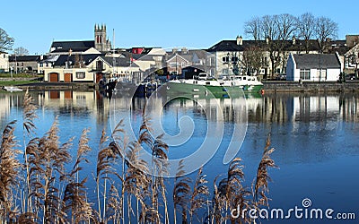 Carrick-on-Shannon, County Leitrim, Ireland viewed from across River Shannon against backdrop of blue sky on winter day Stock Photo