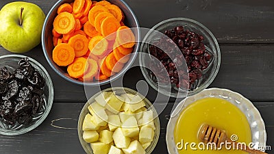 Carrot, apples, honey, dried prunes and cranberry Stock Photo