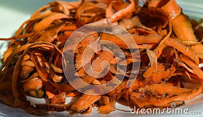 Carrot peelings are on a white plate, preparation for fermentation, zero waste concept. Stock Photo