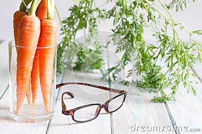 Carrot vitamin A and eyeglasses help your eyes medical concept. Stock Photo