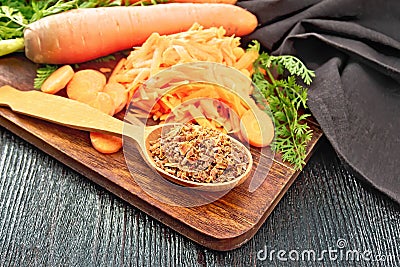 Carrots dried in spoon on dark board Stock Photo