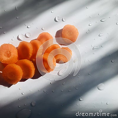 Carrots with water drops in a narrow light. Square photo image. Stock Photo