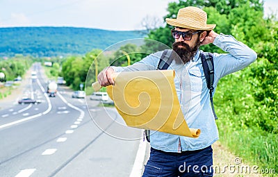 Carry good map. Tourist backpacker looks at map choosing travel destination at road. Allow recognize enough details to Stock Photo