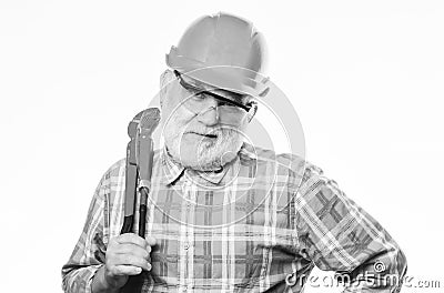Carry out repairs. man builder with adjustable pipe wrench. professional repairman in helmet with gas wrench. architect Stock Photo