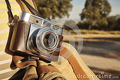 Carrying a vintage camera on the countryside. Outdoor Stock Photo