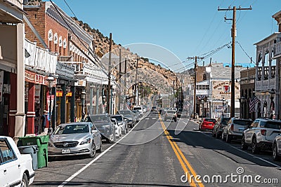 Cars on asphalt road amidst old shops at vintage city during sunny day Editorial Stock Photo