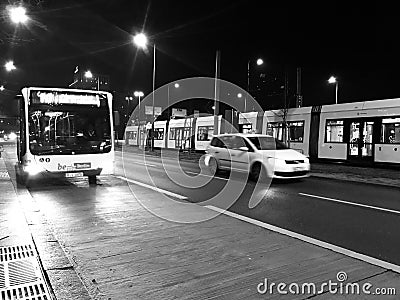 Cars bus and trams running in a busy city streets at night Berlin Editorial Stock Photo