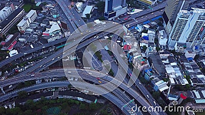 Cars driving on bridge roads shaped curve highways with skyscraper buildings. Aerial view of Expressway Bangna, Klong Toey in Stock Photo