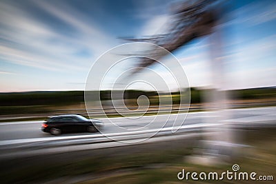 Cars going fast on a highway Stock Photo