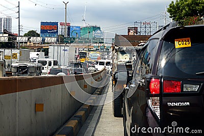 Cars, motorcycles and other vehicles travel along a traffic congested road Editorial Stock Photo