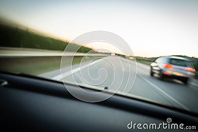 Cars moving fast on a highway Stock Photo