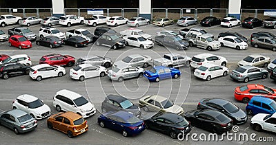 Cars parked in outdoor parking lot at with many of buildings in background Editorial Stock Photo