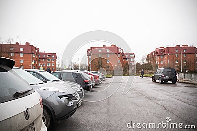 Cars in parking lot and red brick houses, city street - Saint Petersburg, Russia, November 2021 Editorial Stock Photo