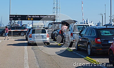 Cars and people waiting to board ferry to island Texel Editorial Stock Photo
