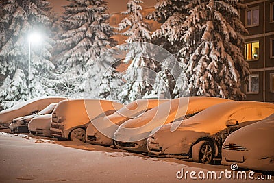 Cars in snow after snowstorm in night, winter photography and snow calamity Stock Photo