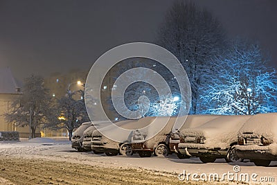Cars in snow after snowstorm in night, winter photography and snow calamity Stock Photo