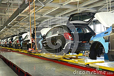 Cars stand on the conveyor line of assembly shop. Automobile pro Stock Photo