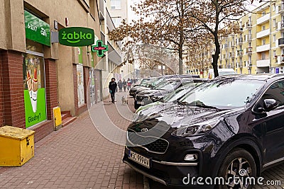 Cars stand in a parking lot on a city street near a cafe Zabka Editorial Stock Photo