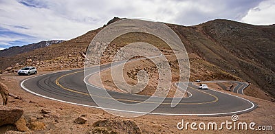 Cars on the steep, winding road up Pikes Peak, Colorado Stock Photo