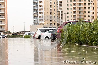 Cars stuck in water in a flooded parking lot after heavy in rain in Dubai Stock Photo