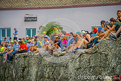 CARTAGENA, COLOMBIA - NOVEMBER 07, 2019: Unidentified spectators sitting in a wall at the independence day parade on the Editorial Stock Photo