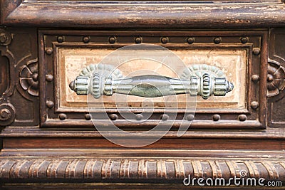 Old wooden and marble door with beautiful iron door handles Stock Photo