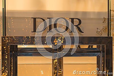 Dior, illuminated jewelry and high couture brand name on Champs Elysees avenue in Paris Editorial Stock Photo