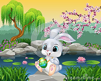 Carton happy Easter Bunny painting an egg on the rock Vector Illustration