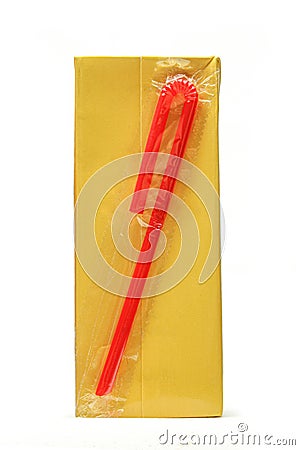 Carton juice box with red plastic straw attached isolated on white background. Stock Photo