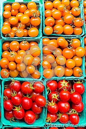 Cartons of orange and red variety of ripe cherry tomatoes Stock Photo