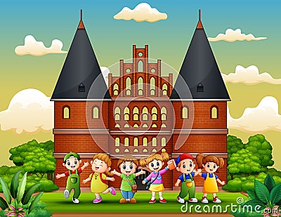 Cartoon of Happy school children standing in front of Holstentor building Vector Illustration