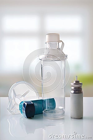 Cartridge inhaler and chamber and mask in room front vertical Stock Photo