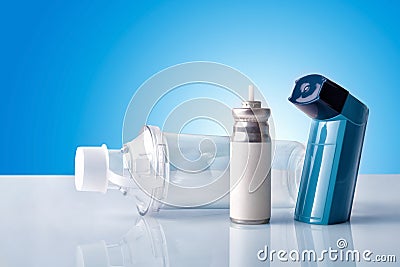 Cartridge inhaler and inhalation chamber with blue background fr Stock Photo