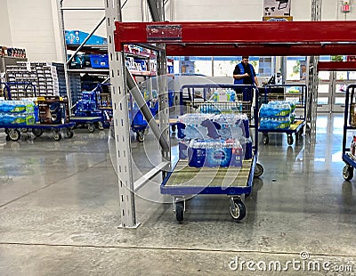 Carts full of cases of bottles of water at a Sams Club wholesale store due to the people panicking and hoarding water products Editorial Stock Photo