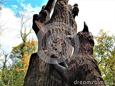 Carved wooden animal sculpture in forest Stock Photo
