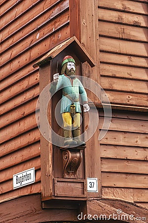 Carved figure of a viking on the side of a wooden building, Bryggen, Bergen, Norway Stock Photo