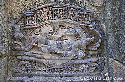 Carved idol of Lord Vishnu on the inner wall of a small shrine. Built in 1026 - 27 AD during the reign of Bhima I of the Chaulukya Stock Photo