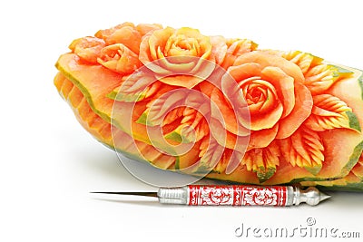 Carved papaya fruit and knife Stock Photo