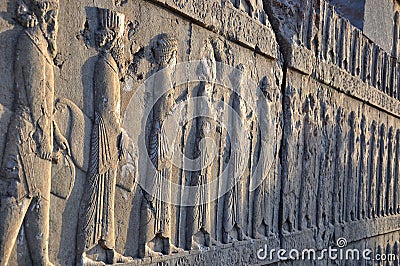 Carved Persians on the stone wall in Persepolis Stock Photo