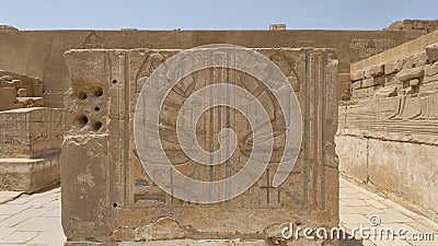 Carved relief on a stone pillar base in the Hypostyle Hall of the Mortuary Temple of Ramesses III in Medina Habu. Stock Photo