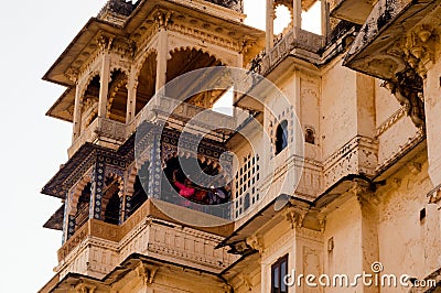 Carved sandstone exterior walls of the udaipur palace with arches, balcony and windows Editorial Stock Photo