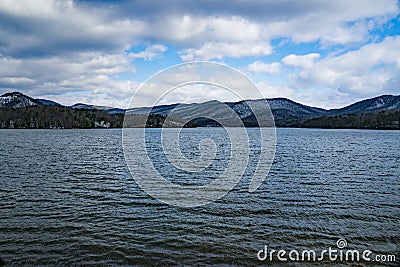 Carvin Cove Reservoir with a Snowy background of Bushy Mountain Stock Photo