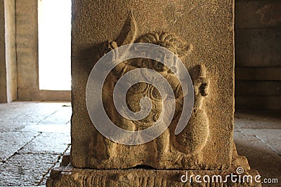 Carving of a strange figure, apparently cutting jackfruit in Vittala temple Stock Photo