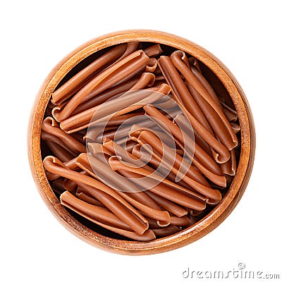 Casarecce pasta, short twists of gluten free pasta, in a wooden bowl Stock Photo