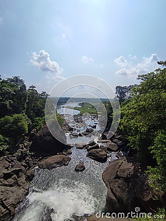 The Cascading Beauty of a Rocky River Embellished with Lush Trees Stock Photo