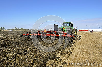 Case IH chisel plow and John Deere tractor Editorial Stock Photo