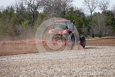 New Lisbon, Wisconsin USA - May 4th, 2022: Farmer driving a Case 305 Magnum tractor while pulling a plow to plow up a farming fiel Editorial Stock Photo