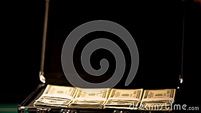 Case with money on black background, cover-up illegal business, corruption Stock Photo