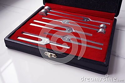 Case of Set of Tuning Forks for hearing tests on a marble background . Medical equipment. Stock Photo