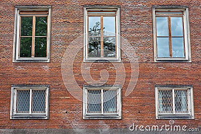 Casement windows in red brick wall Stock Photo